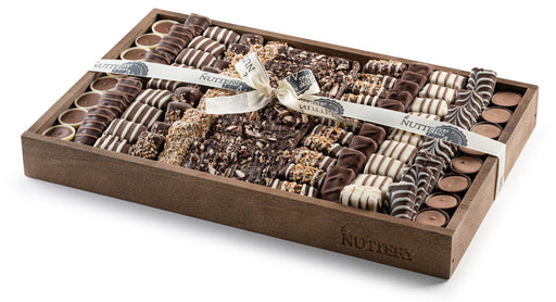 A sleek and sophisticated chocolate gift tray packed with rich, handcrafted confections. Tied with a satin ribbon, this elegant presentation makes for a perfect gift.