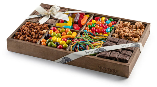 Medium-sized wooden gift tray with eight sections featuring an assortment of chocolates, nuts, and candies, including fudge bites, salted cashews, jelly beans, and sour spaghettis.