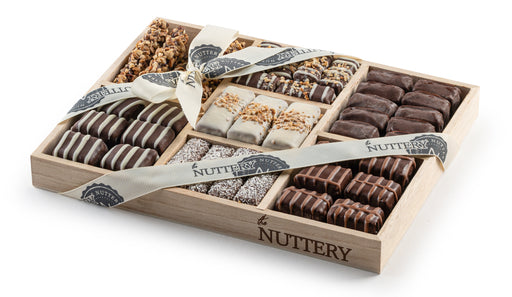 Experience the perfect balance of premium chocolate bark and roasted nuts, elegantly packed in a seven-section wooden tray. A gourmet gift that’s perfect for any occasion.