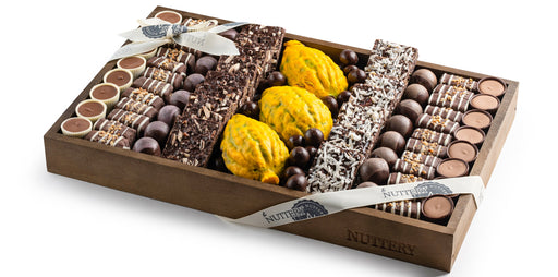 A sophisticated Sukkot-themed gift tray, featuring handcrafted chocolate bars, chocolate-covered nuts, and decorative esrog fruit. A stunning presentation for the holiday season.