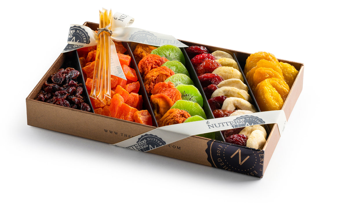 The Nuttery Shana Tova Classic 5 Section Gift Box – a vibrant assortment of gourmet dried fruits, including apricots, kiwi, mango, bananas, and cranberries, elegantly arranged with honey sticks in a premium gift box.