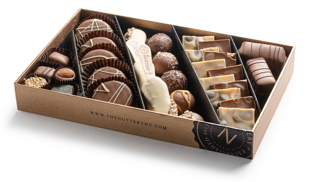 A premium chocolate assortment in a luxury gift tray featuring hand-decorated truffles, nut clusters, and chocolate bars for a refined indulgence.
