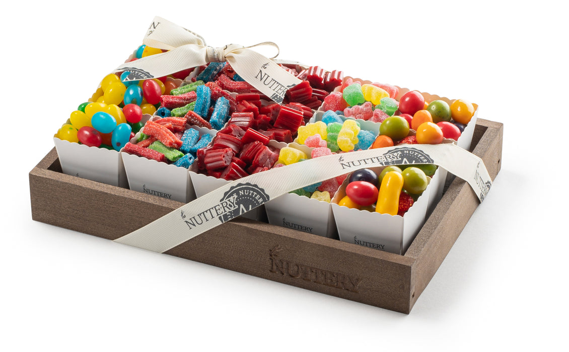 Small candy gift tray from The Nuttery NY featuring 15 individual party cups filled with colorful gummy candies, sour belts, licorice, and chocolate-covered treats, elegantly wrapped with a branded ribbon