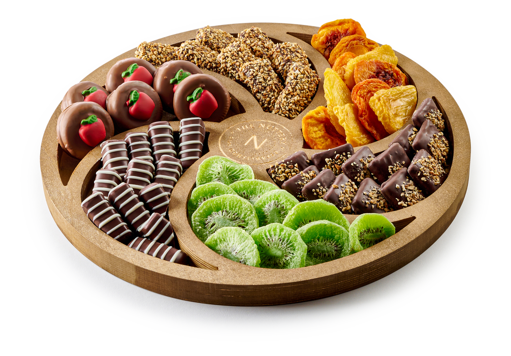 The Nuttery Shana Tova large Swirl Tray is a beautifully arranged selection of chocolates and dried fruits, elegantly presented in a handcrafted wooden tray. With a mix of rich chocolate confections and naturally sweet dried fruit, this Rosh Hashanah gift is both sophisticated and delicious.