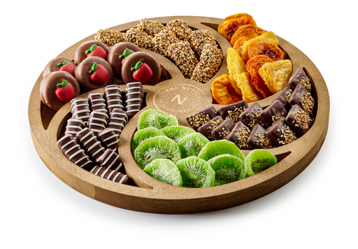 The Nuttery Shana Tova large Swirl Tray is a beautifully arranged selection of chocolates and dried fruits, elegantly presented in a handcrafted wooden tray. With a mix of rich chocolate confections and naturally sweet dried fruit, this Rosh Hashanah gift is both sophisticated and delicious.