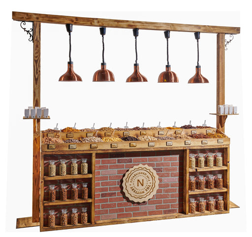 A full view of The Nuttery’s wooden nut station with copper pendant lights, featuring a brick backdrop and shelves filled with nut jars