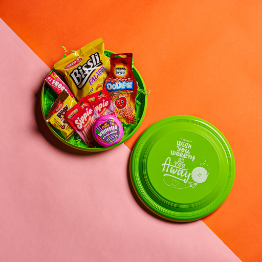 A playful and colorful snack box packed in a custom frisbee lid, featuring a selection of camp-favorite treats and candies. A unique gift for kids, campers, and snack lovers who enjoy fun and flavor in one package in an alternate positon