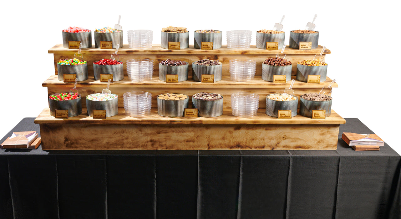 A grand multi-tiered setup of premium snacks, including hand-picked chocolates, nuts, and sweets, designed for luxury catering and event entertainment.