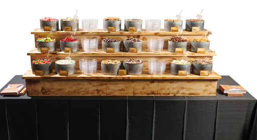 A grand multi-tiered setup of premium snacks, including hand-picked chocolates, nuts, and sweets, designed for luxury catering and event entertainment.