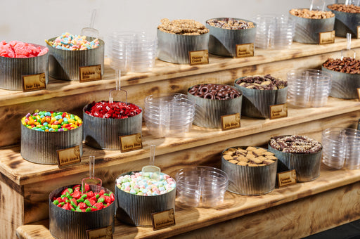 This tiered display of gourmet treats offers a stunning variety of premium chocolates, nuts, and sweets, perfect for parties, events, and catering