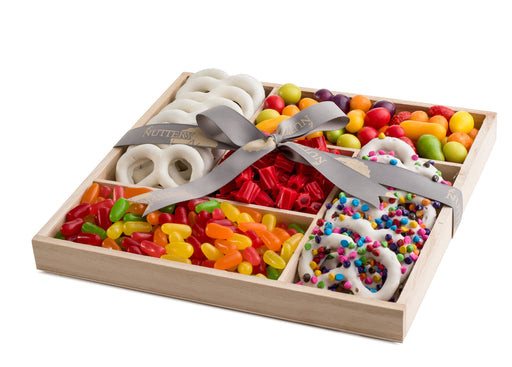 Candy and pretzel gift tray with five sections featuring yogurt-covered pretzels, Twizzlers, jelly beans, and colorful chocolate candies, tied with a branded ribbon.