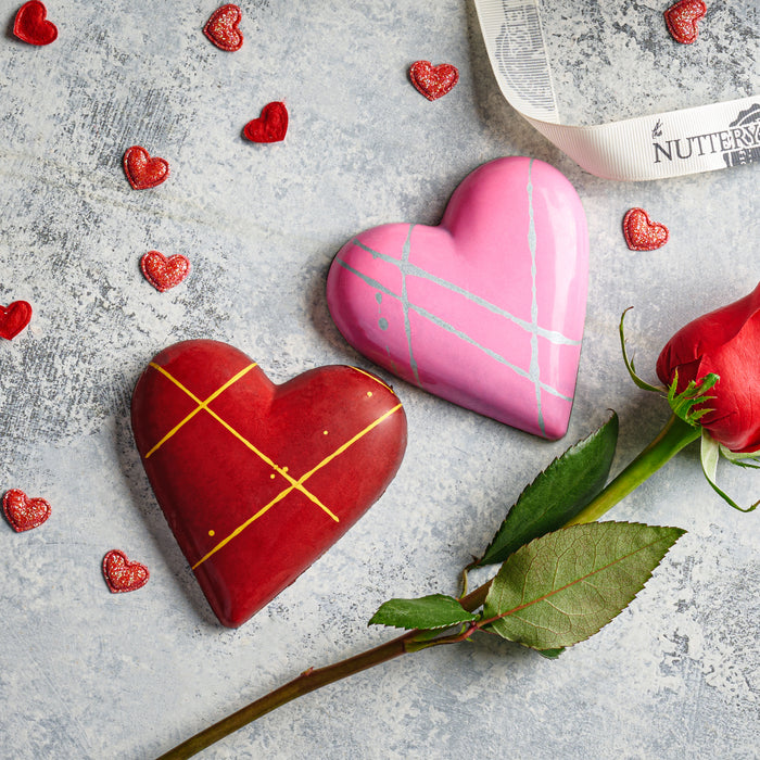 A romantic collection of heart-shaped gourmet chocolates in stunning red and pink hues. The perfect Valentine’s Day gift to express love and indulgence in every bite.