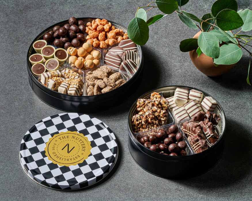 The Nuttery NY gourmet chocolate and nut tin, elegantly wrapped with a customizable tag, featuring a stylish checkered design, perfect for corporate gifts and special occasions.