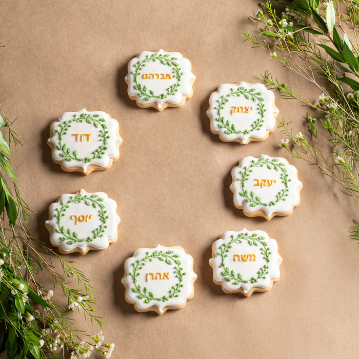 Nuttery Ushpizin cookies decorated with Hebrew names, perfect for Sukkot celebrations. These elegant sugar cookies feature detailed green and gold icing, adding a festive touch to the holiday table.