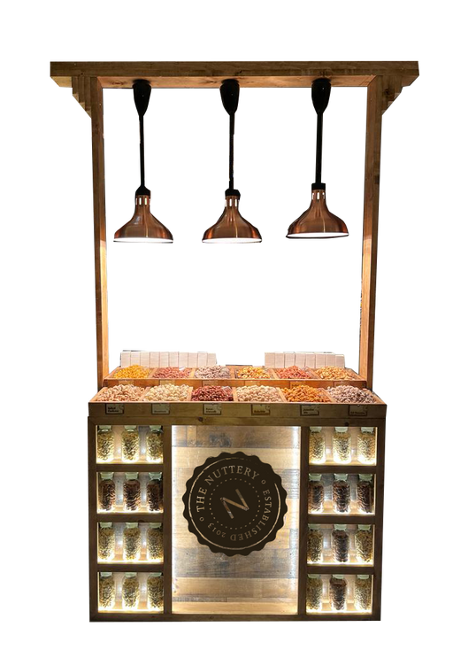 The Nuttery’s wooden nut station with illuminated shelving and copper pendant lighting, showcasing a variety of premium nuts.
