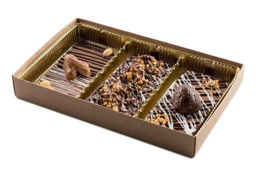 Handcrafted chocolate tarts from The Nuttery, featuring decadent toppings such as nuts, cookies, and drizzled chocolate